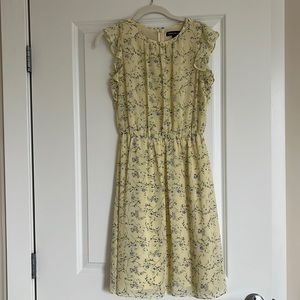 Light yellow dress with purple flowers.